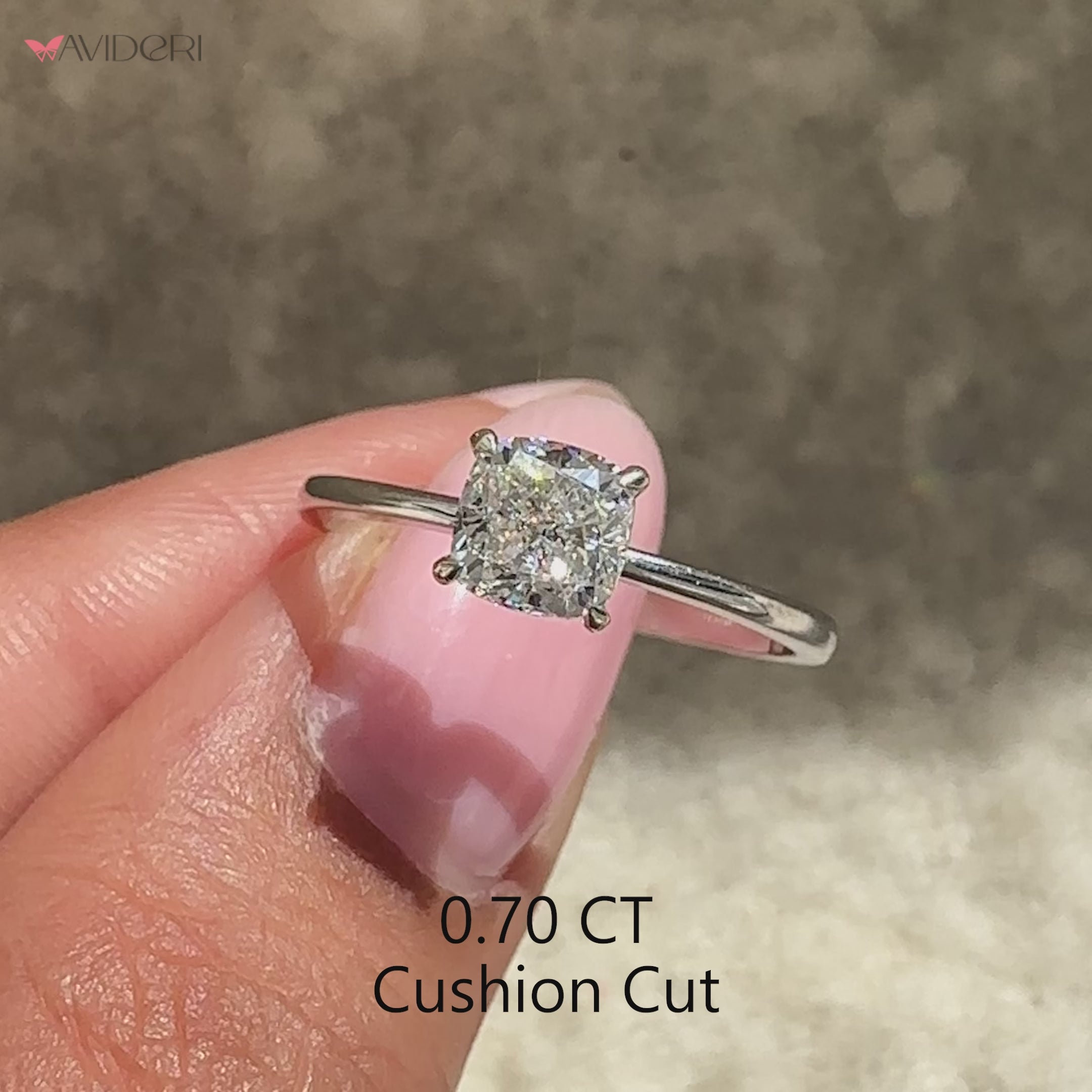 Cushion cut diamond ring featuring four claw prongs.