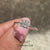 Cushion cut diamond ring featuring four claw prongs.