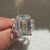 IGI certified emerald engagement ring with three stone design
