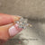 Radiant diamond cut ring with a brilliant round cut diamond ring setting.
