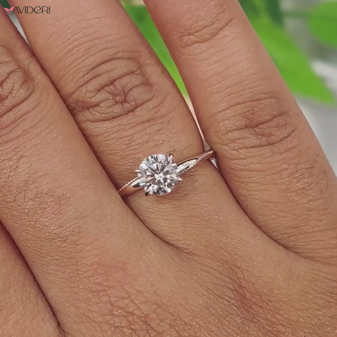 Milgrain ring showcasing a solitaire diamond with round cut brilliance, perfect for timeless engagement moments.
