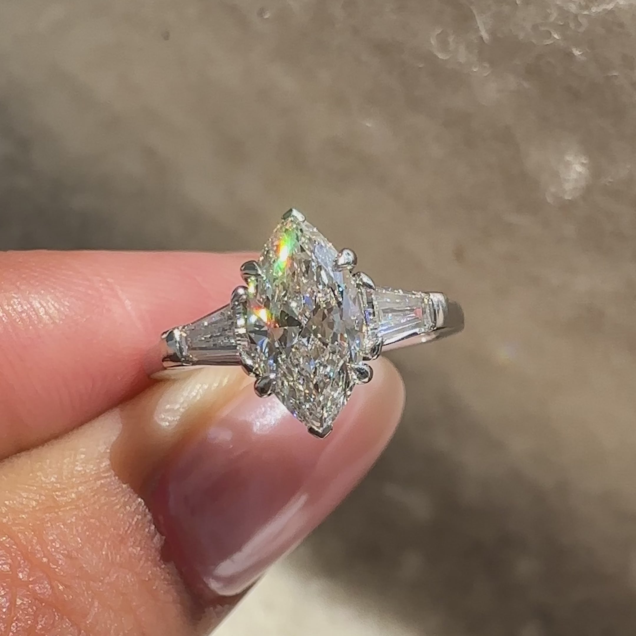Basket setting marquise ring with baguette sides.
