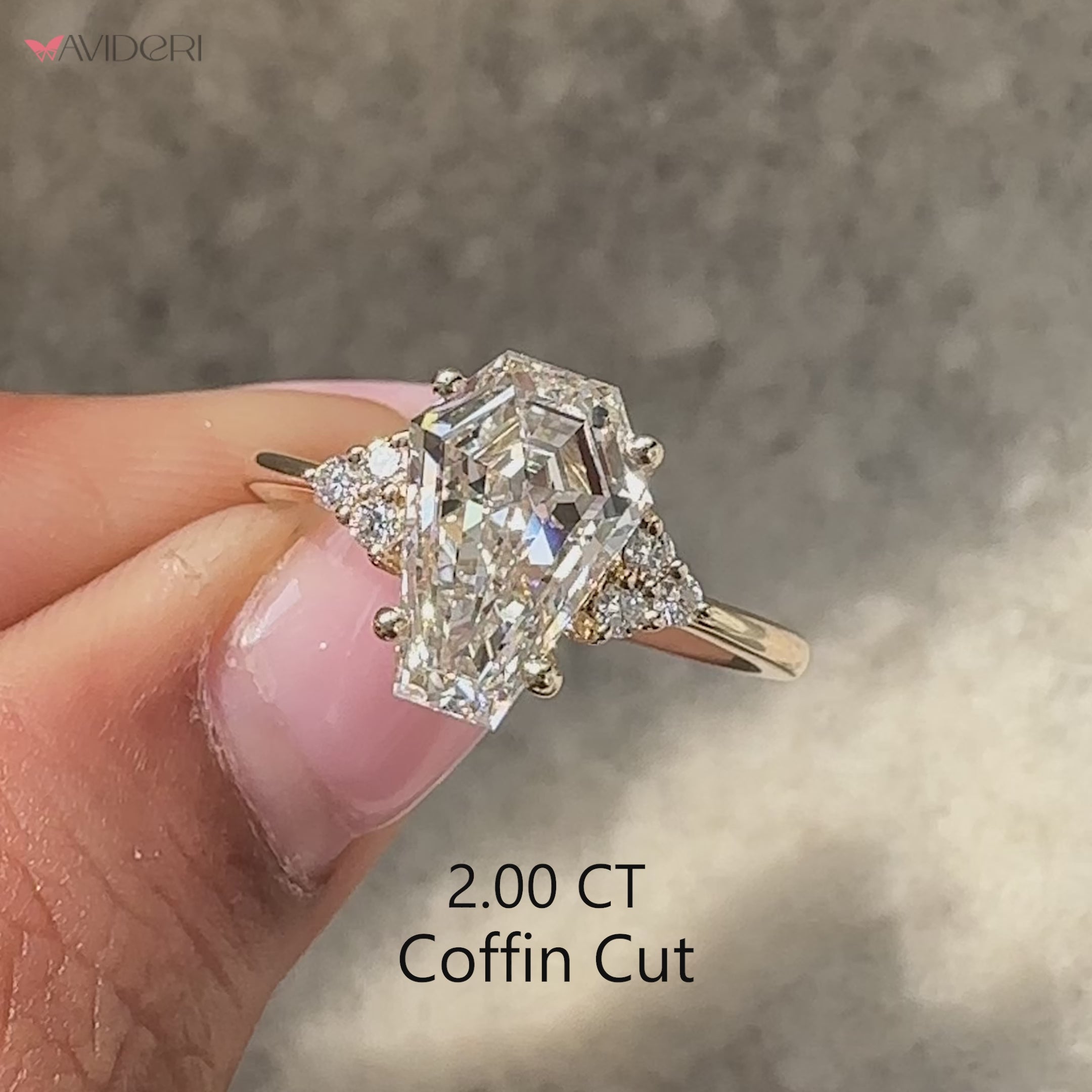 Coffin cut seven stone ring with round side stones.