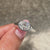 Handmade oval cut diamond ring with clean lines.
