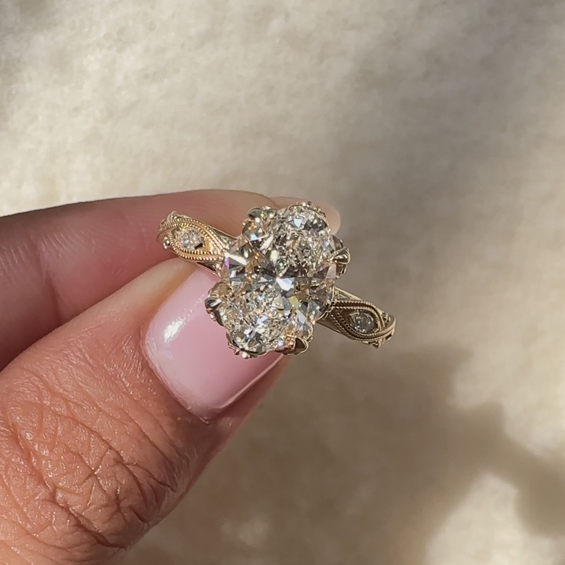 Oval diamond ring with pave and side stones.
