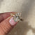 Oval diamond ring with pave and side stones.
