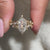 Marquise and round side stone in dutch marquise engagement ring.