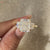 Radiant moissanite ring with balanced three stone design.
