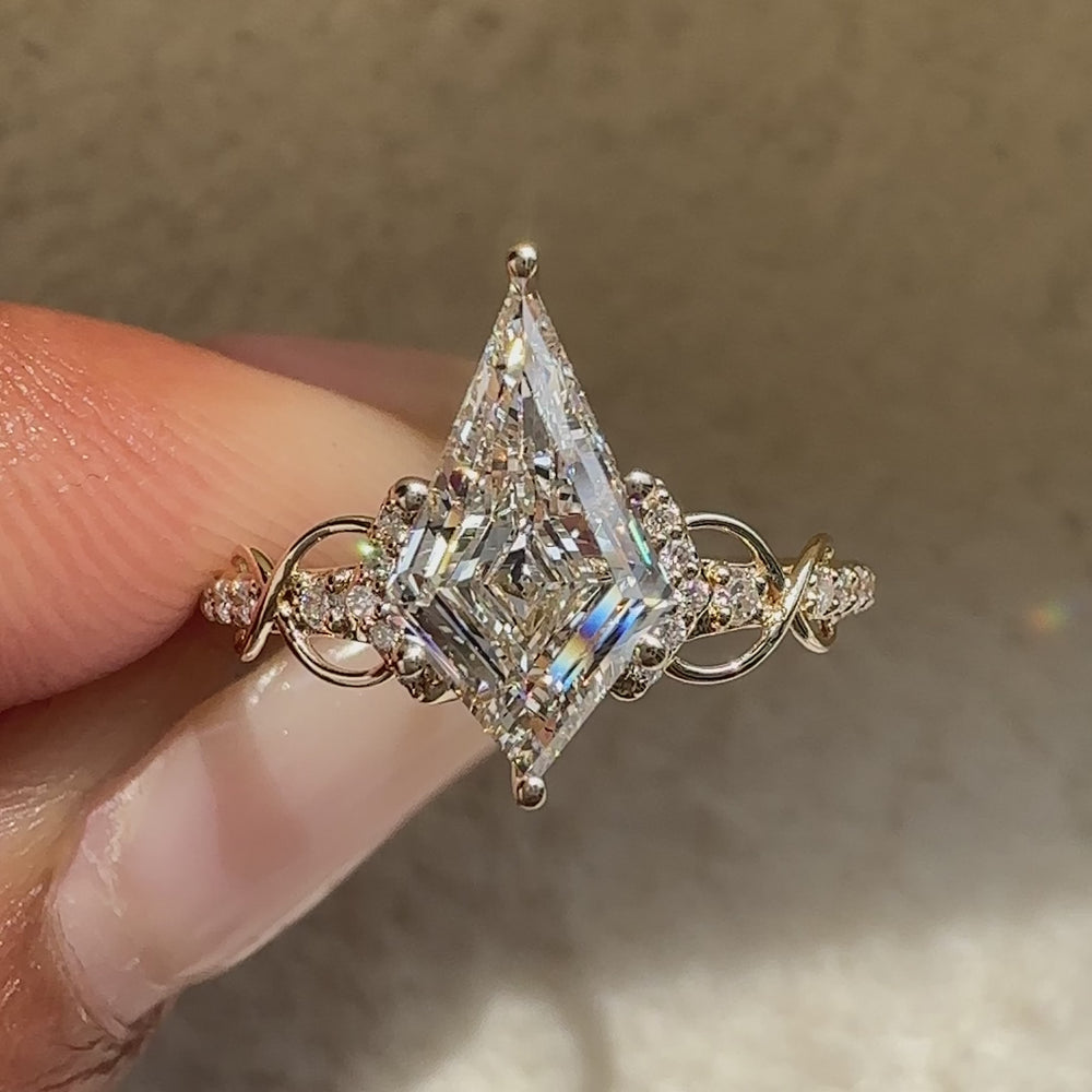 Kite diamond engagement ring with twisted pave band.
