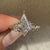 Kite diamond engagement ring with twisted pave band.
