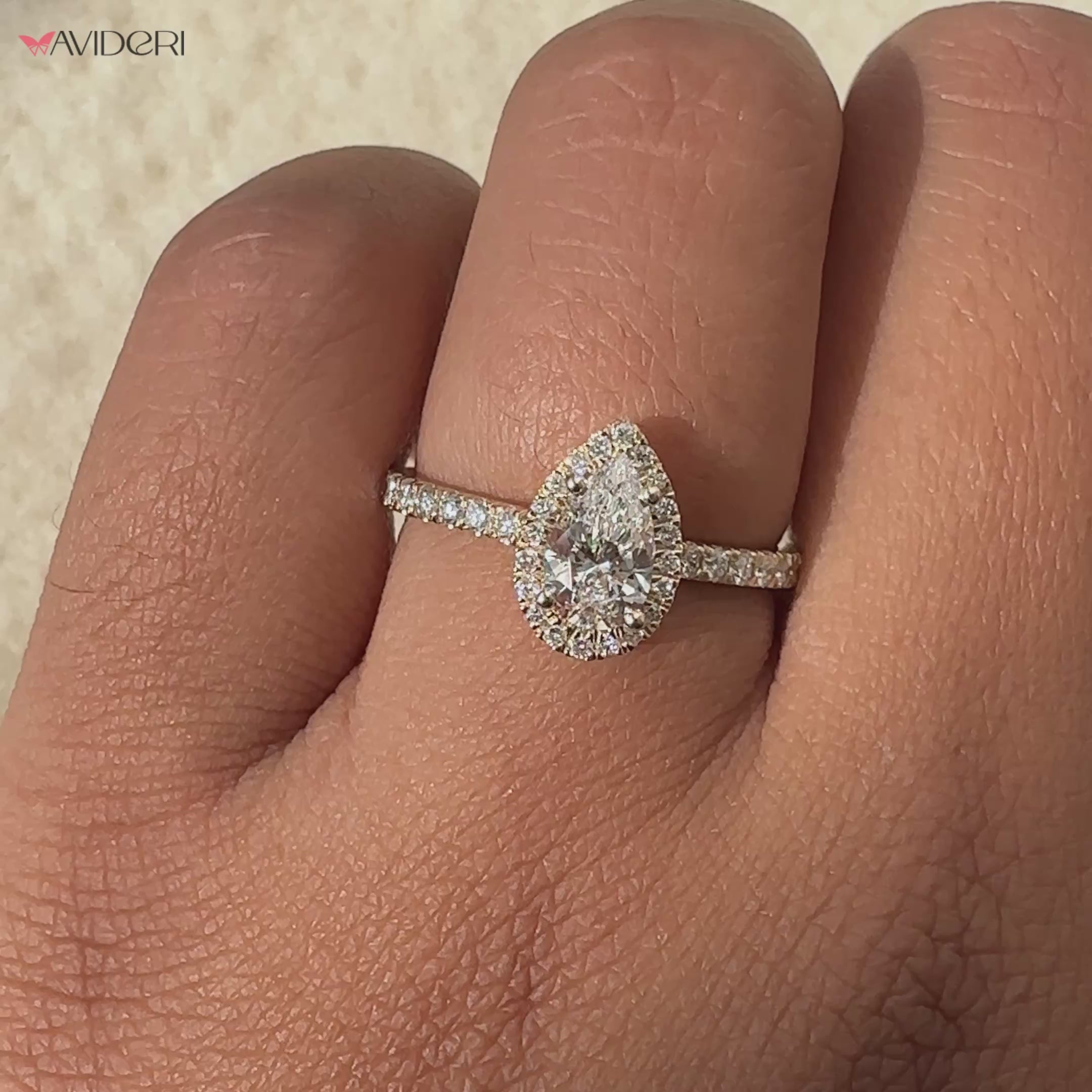 Pear shape diamond ring featuring a beautiful halo setting.
