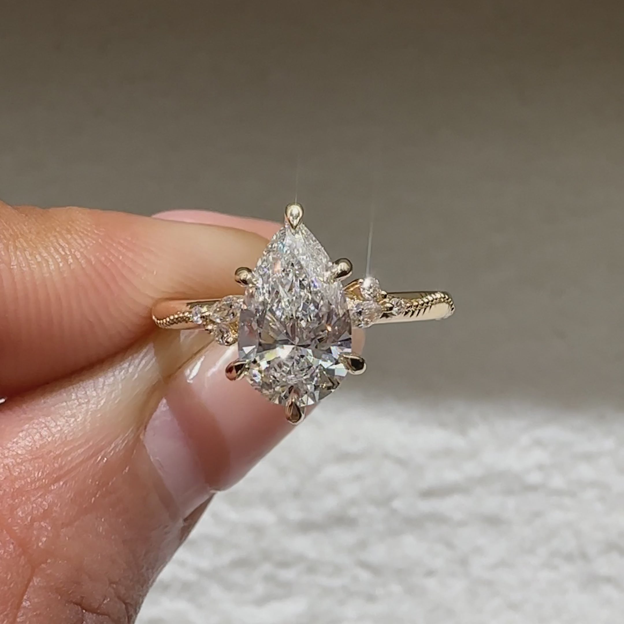 IGI certified pear ring with marquise side stone accents
