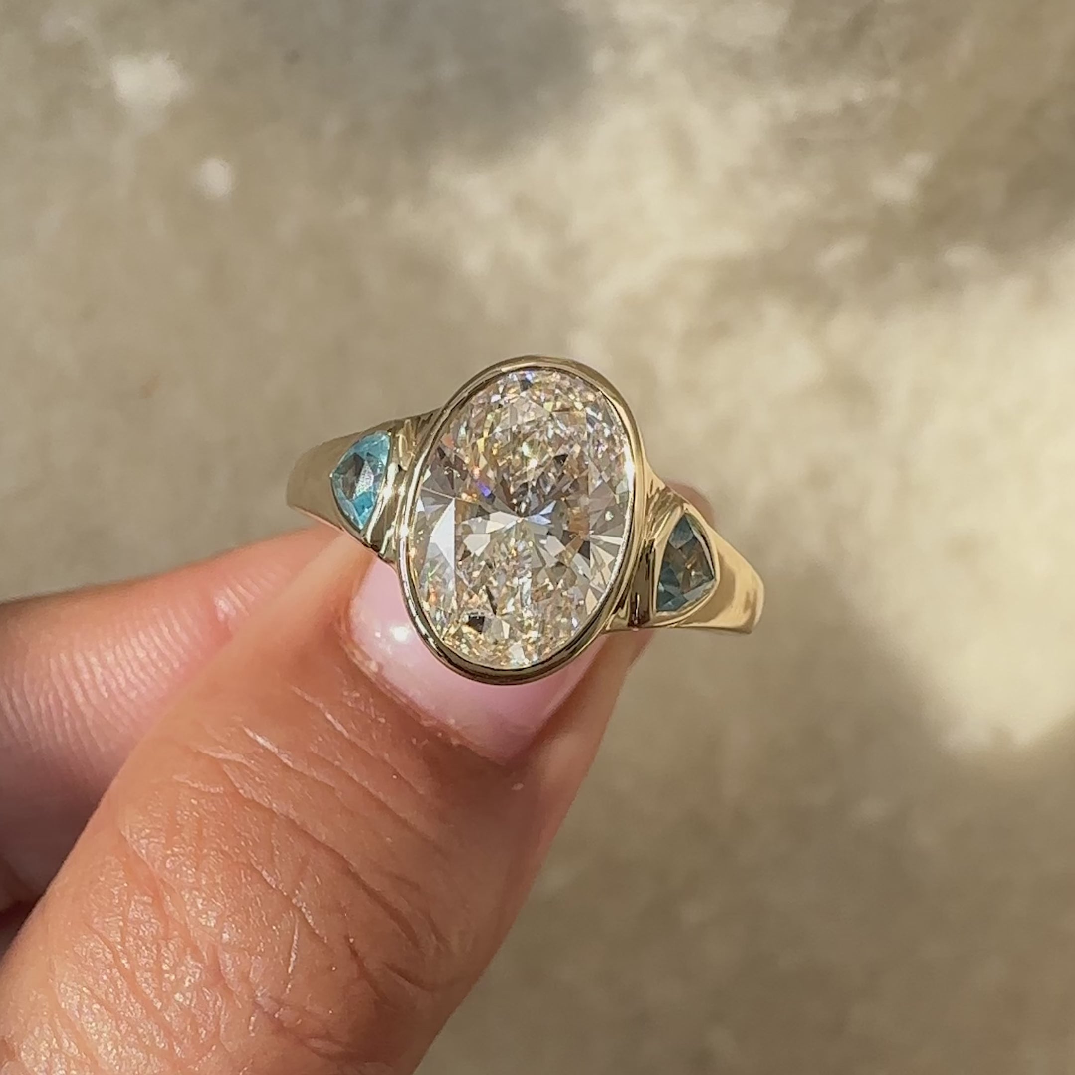 Avideri ring with bezel set oval diamond.