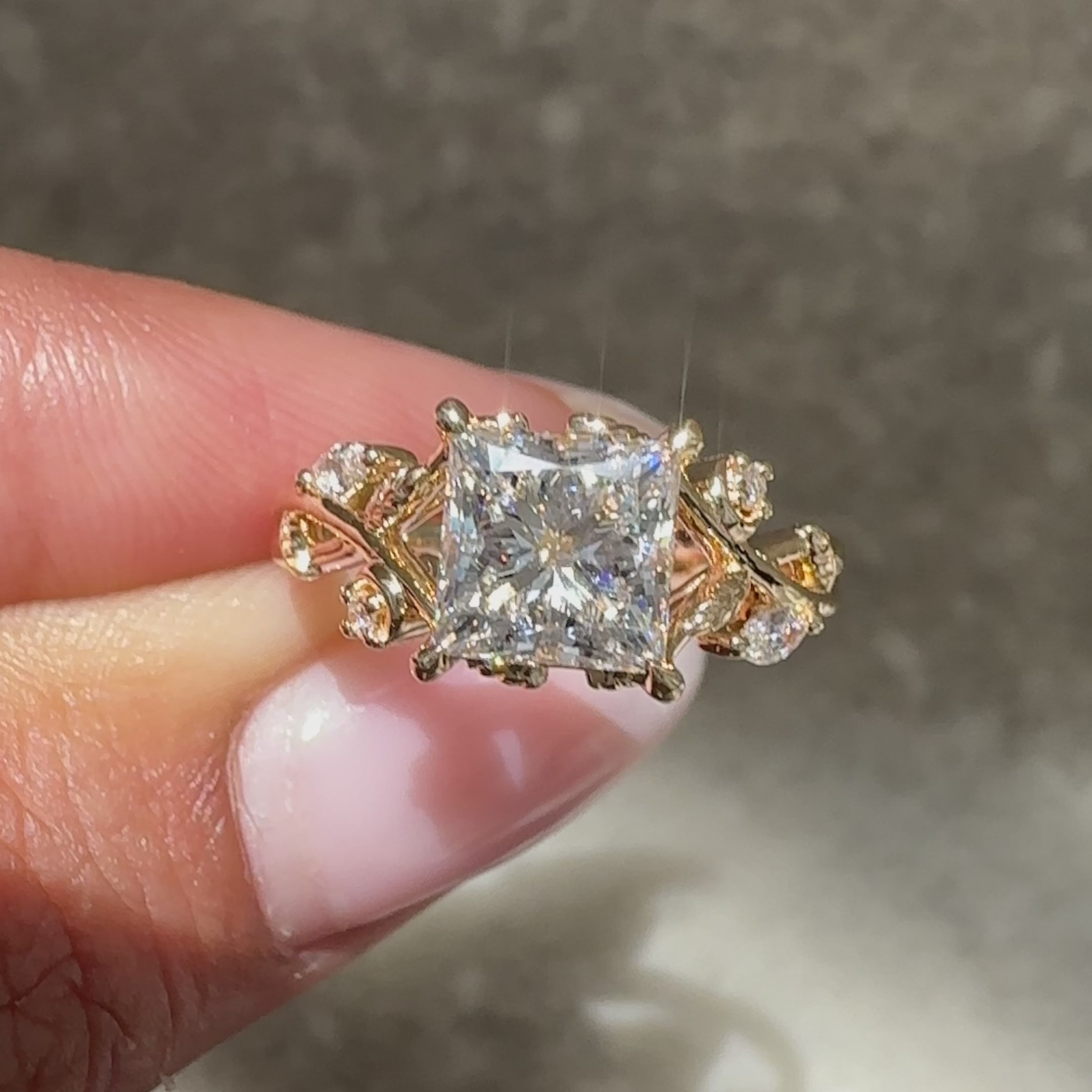 Princess cut diamond ring with side stones.