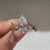 Pear shaped lab diamond ring with decorative leaf prongs
