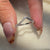 Curved wedding band with round diamonds and a half side eternity design.
