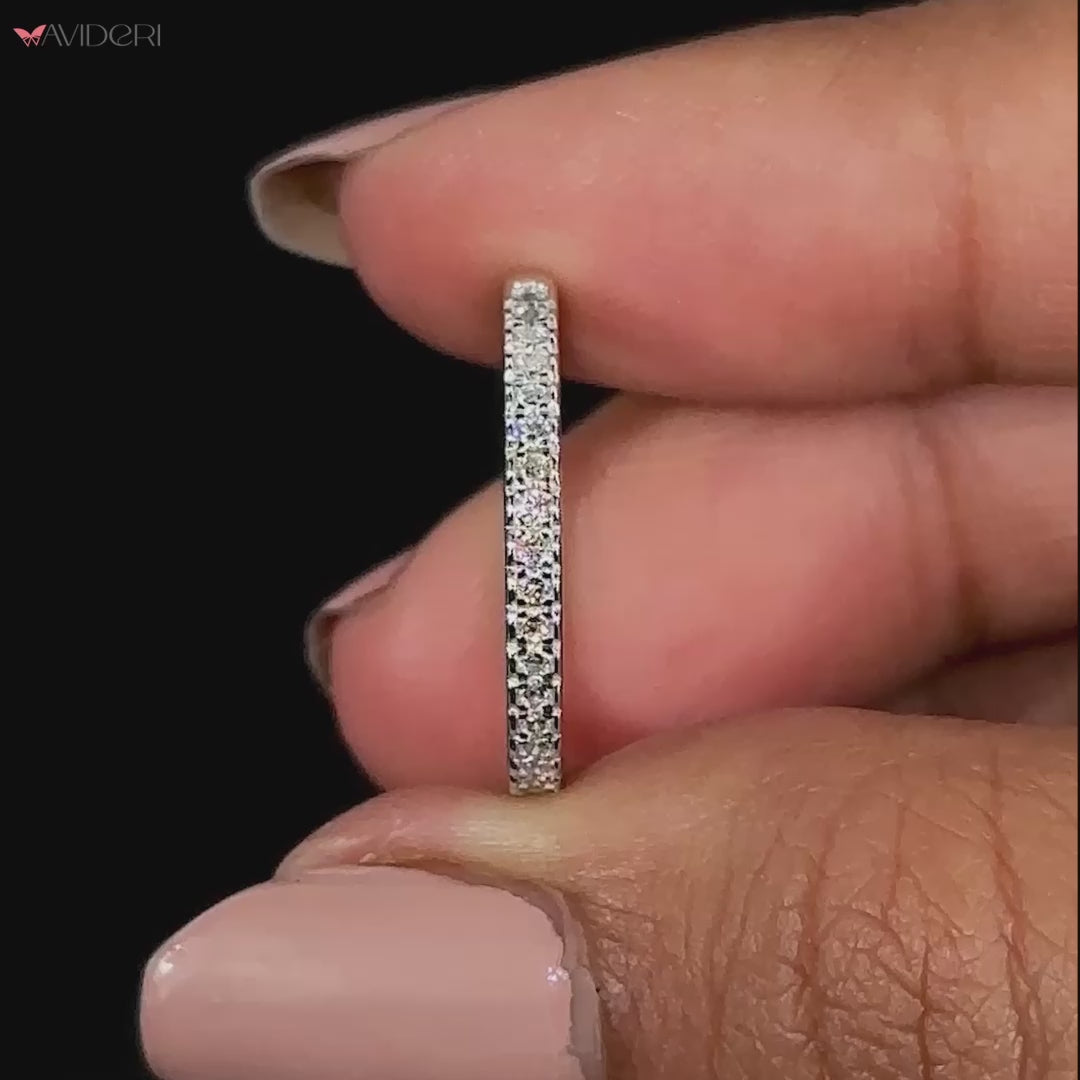 Close-up of a round diamond half eternity band handcrafted in white gold.
