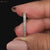 Close-up of a round diamond half eternity band handcrafted in white gold.
