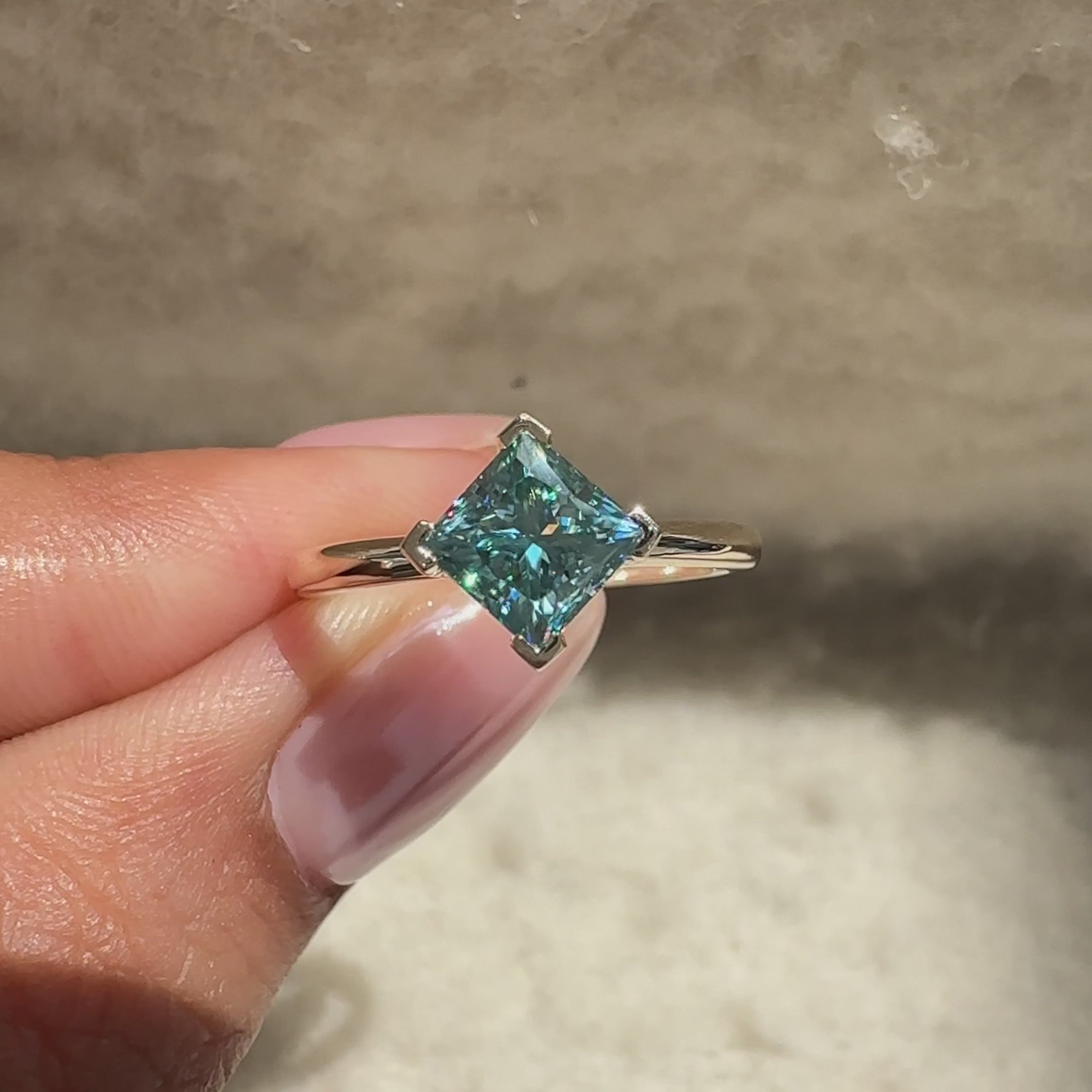 Cyan blue moissanite ring with solitaire style.

