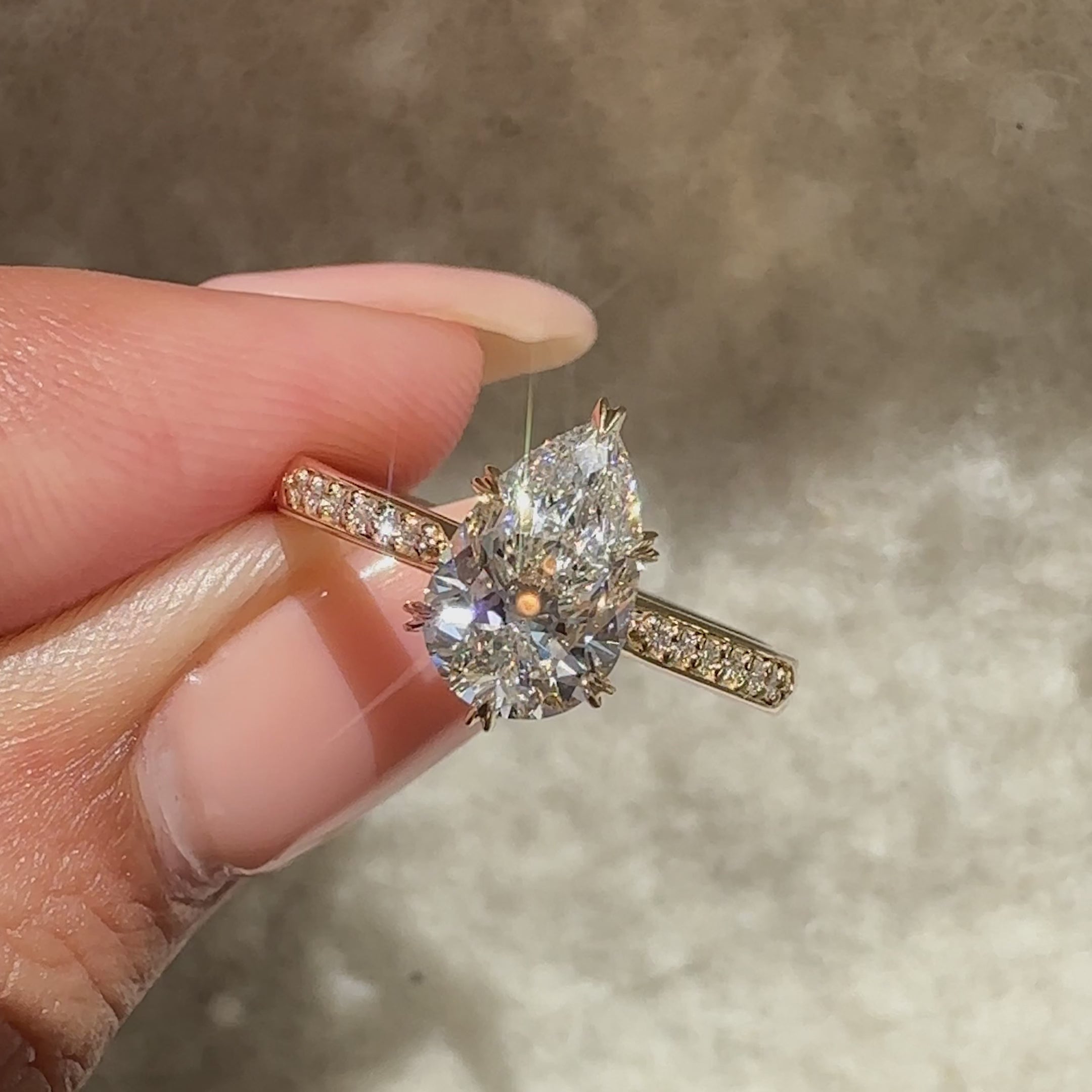 Pear diamond ring with sparkling pave band.
