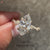 Marquise cut diamond ring with modern twisted band.
