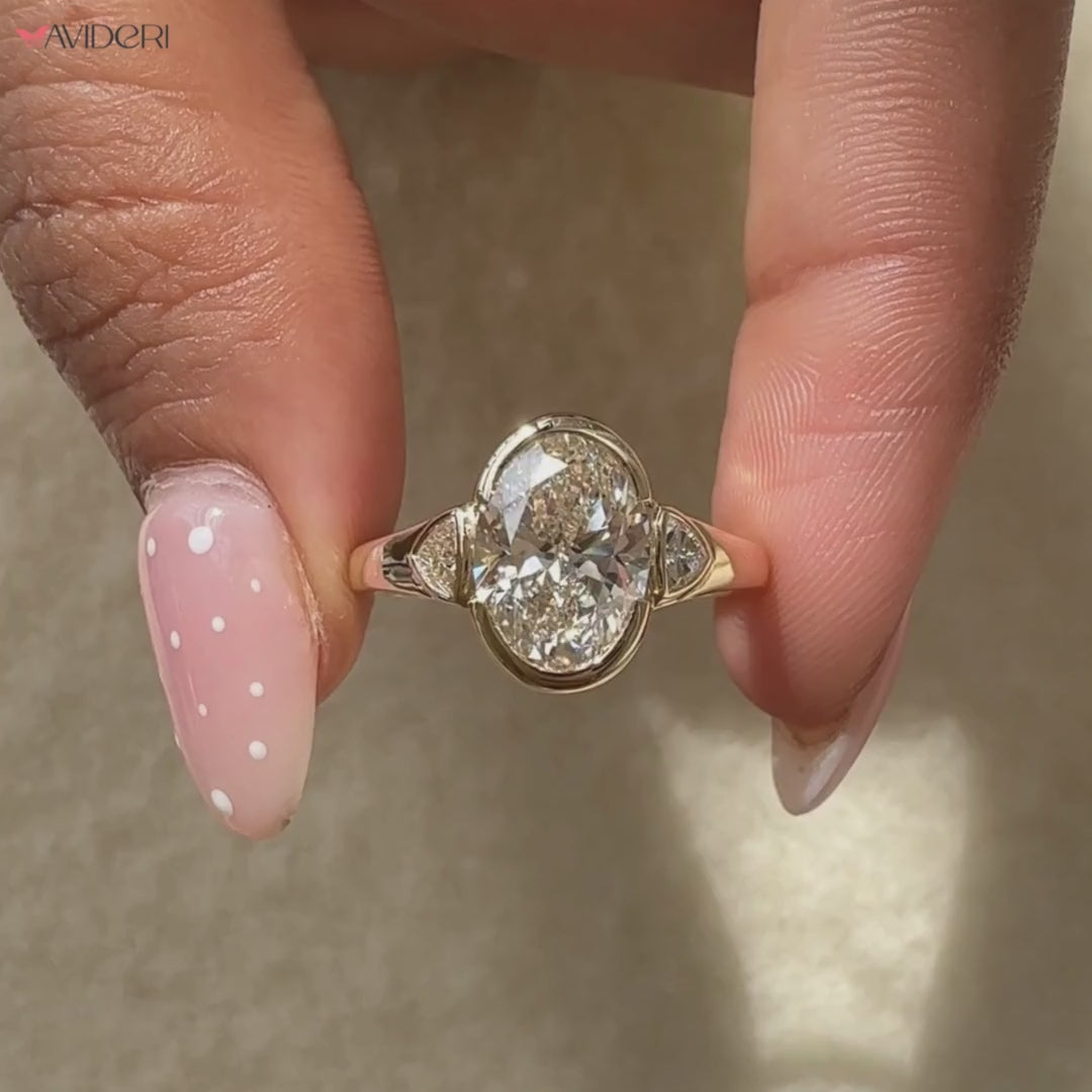 Handmade ring with oval diamond engagement ring accent.