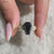 Moissanite engagement ring in black coffin engagement ring.