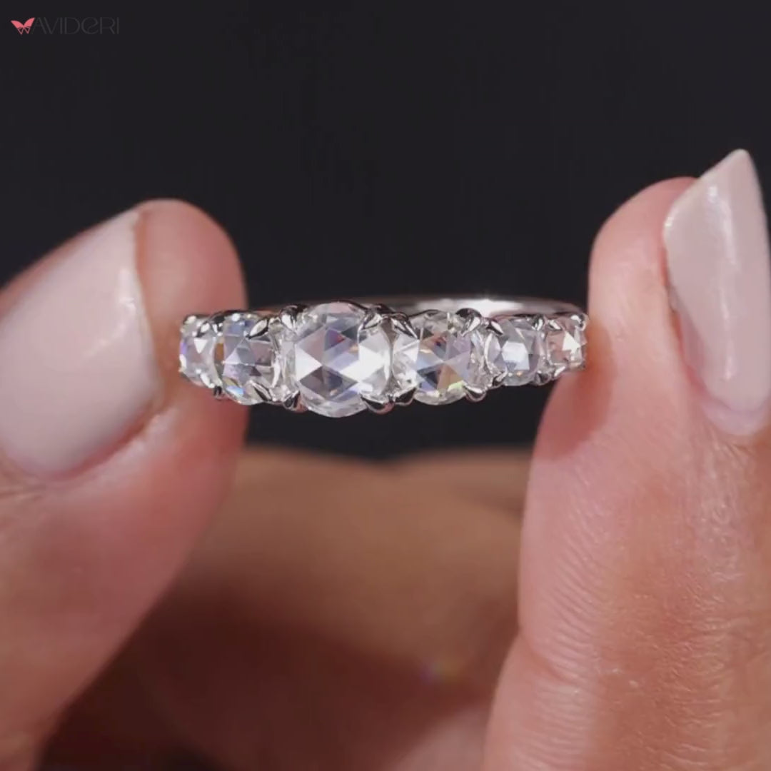 Seven round rose cut stones shine in claw prong white gold.
