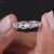 Seven round rose cut stones shine in claw prong white gold.
