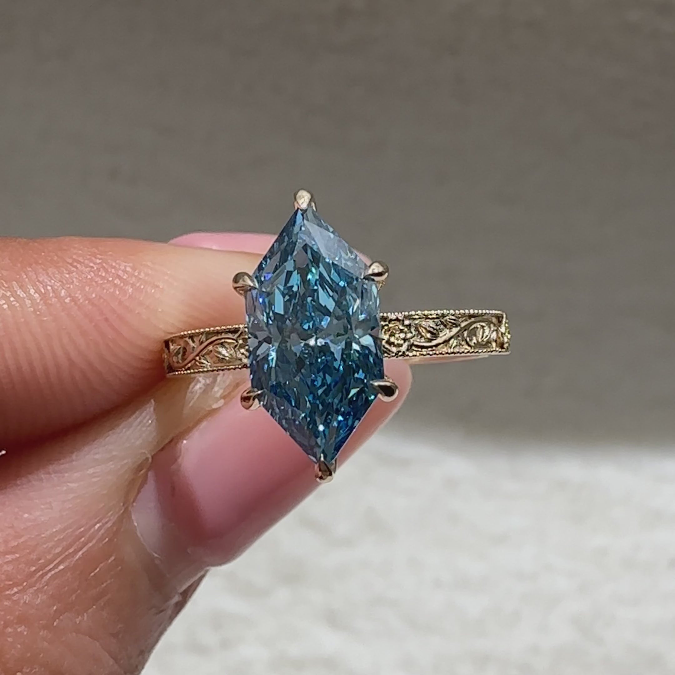 Dutch marquise blue diamond engagement ring with floral details
