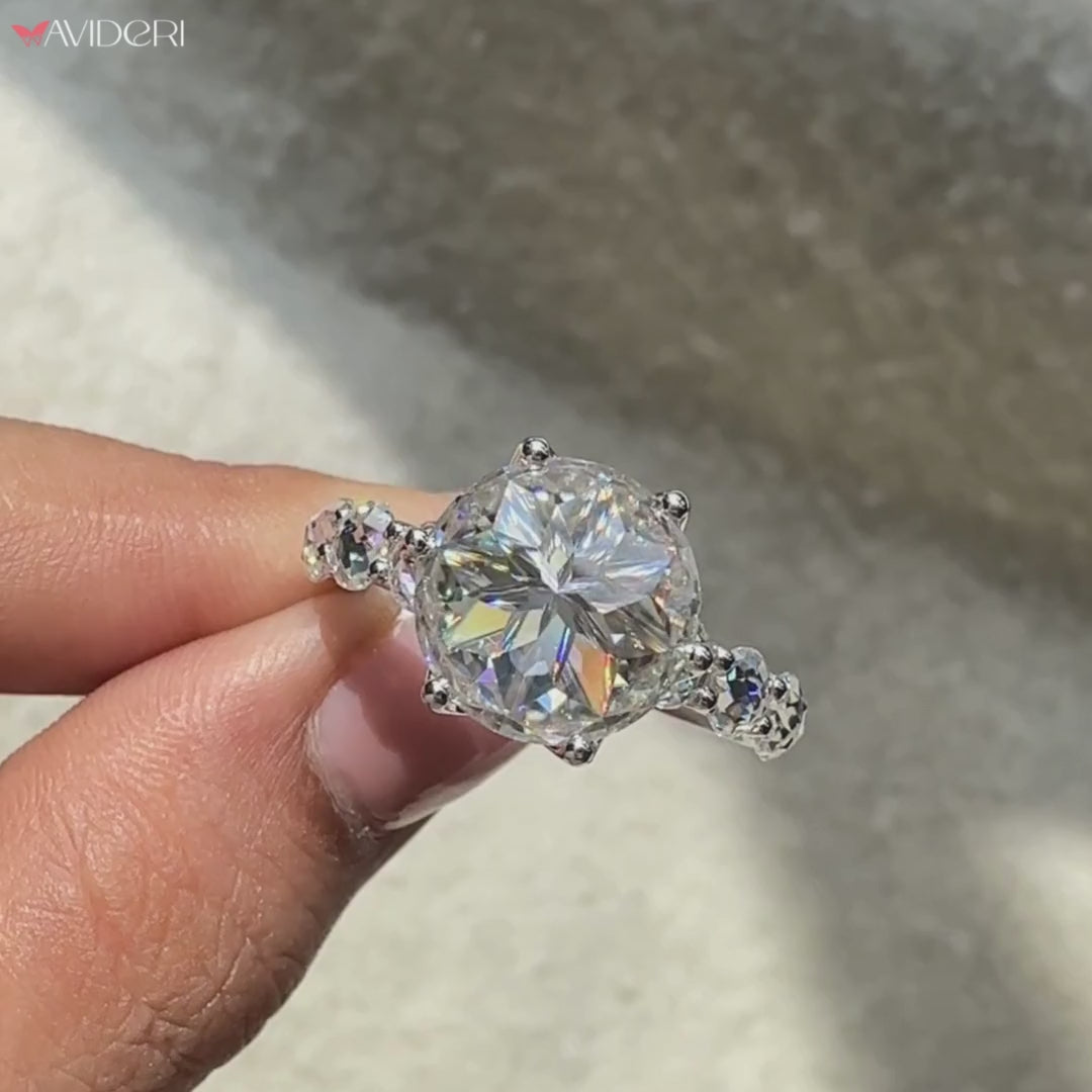 Moissanite engagement ring with U prong pave setting.