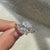 Moissanite engagement ring with U prong pave setting.