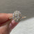 Lab grown oval diamond ring with cathedral and halo
