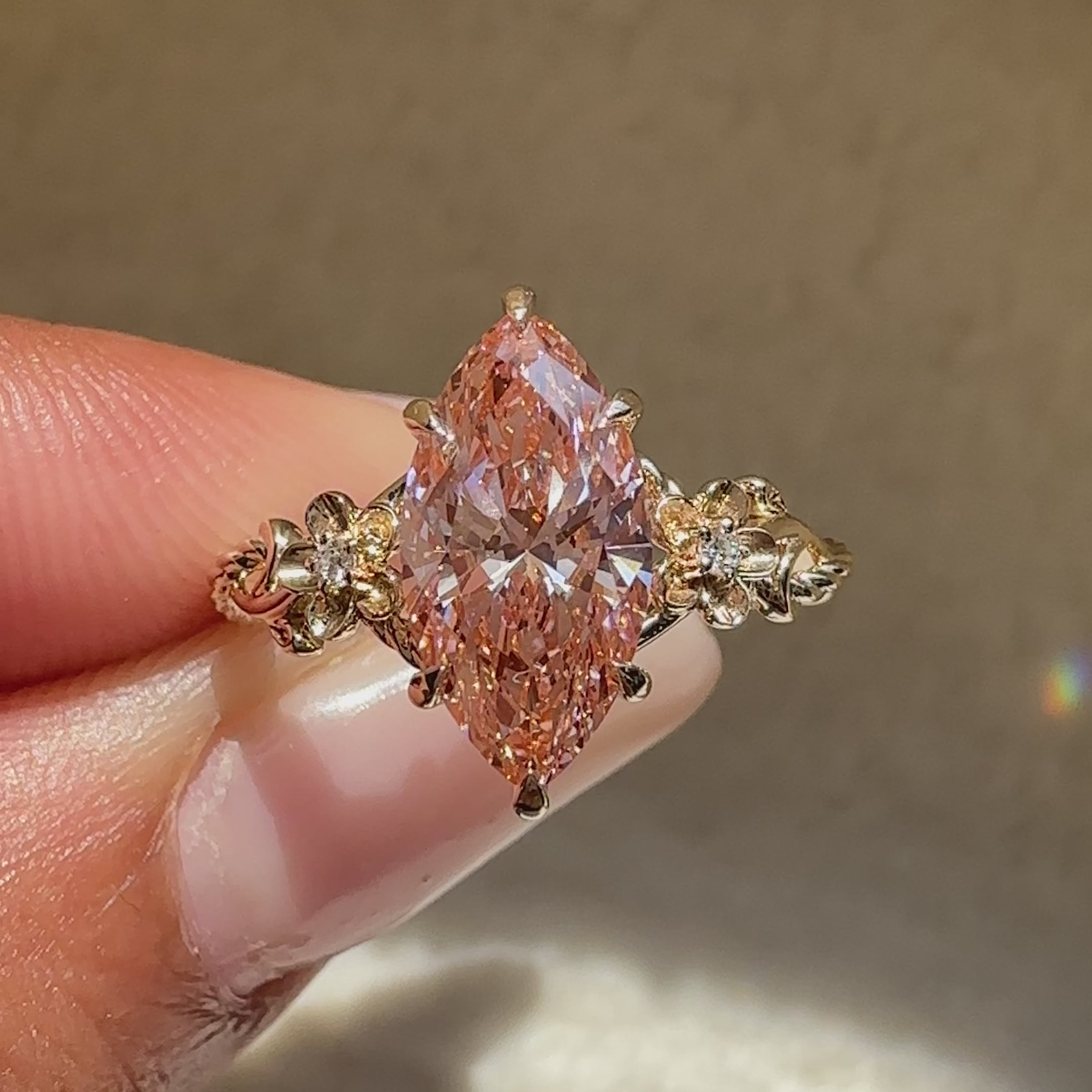 Marquise diamond ring with floral bloom detailing.
