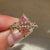Marquise diamond ring with floral bloom detailing.
