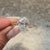 Oval diamond ring with detailed engraved design.
