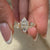 Cluster diamond ring paired with lab-grown ring.