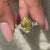 Moissanite engagement ring in white gold with pear cut center and baguette side accents.
