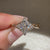 Tapered shank marquise diamond ring with side stones.
