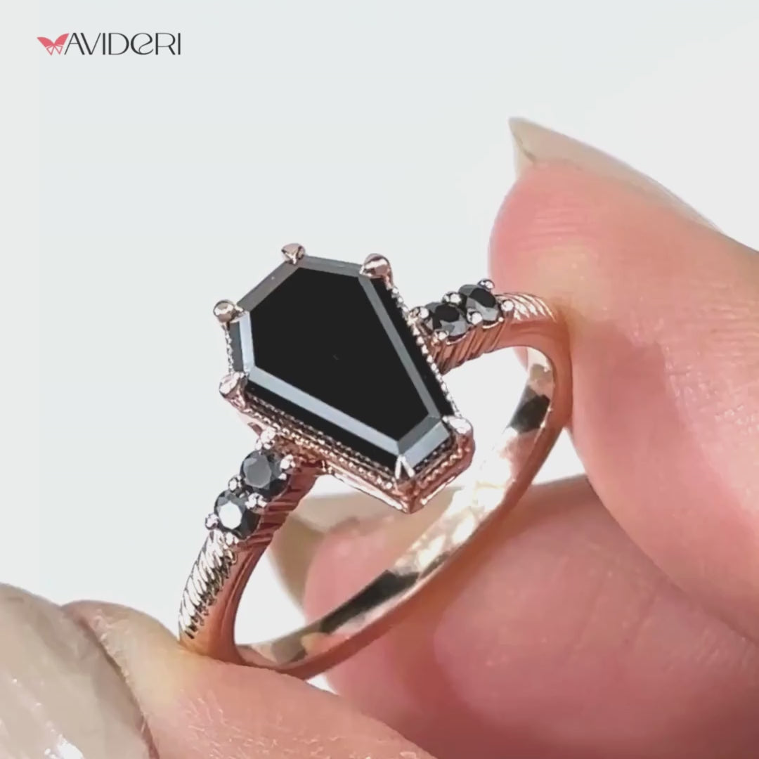 Elegant coffin ring featuring a brilliant round cut center stone.
