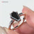 Elegant coffin ring featuring a brilliant round cut center stone.
