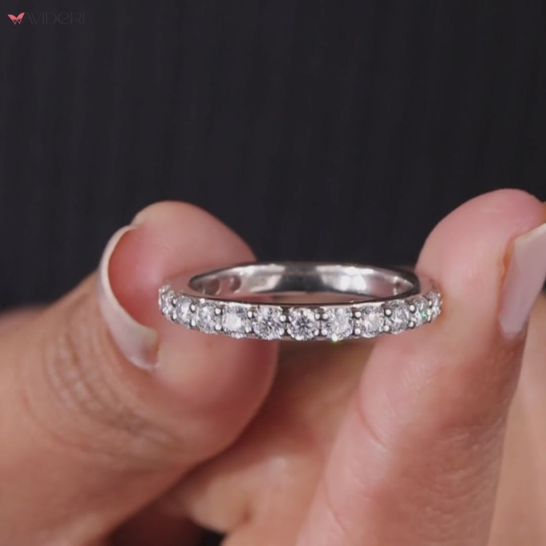 Round prong set stones complement the half eternity layout in white gold.

