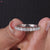 Round prong set stones complement the half eternity layout in white gold.
