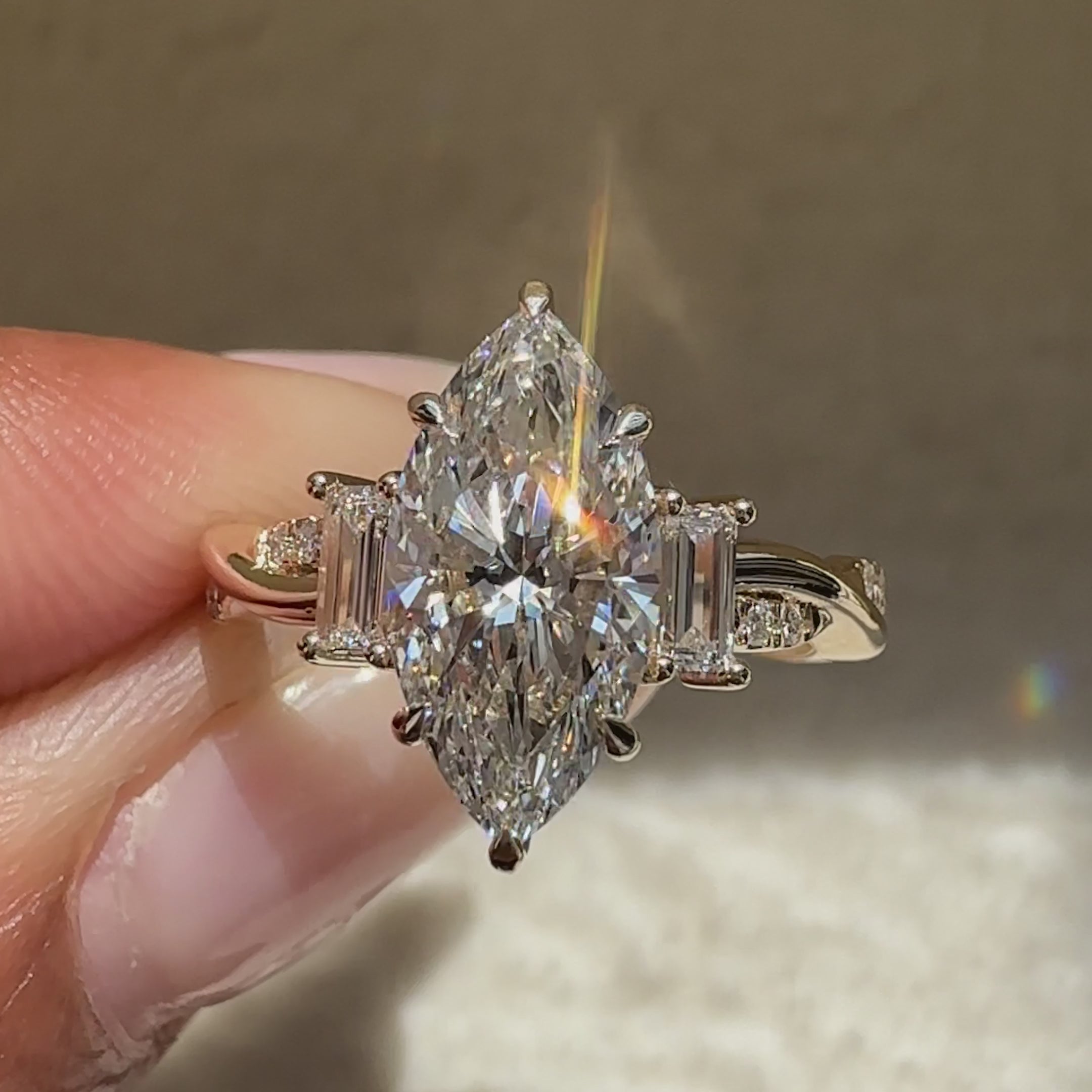 Marquise diamond ring with six claw prongs.
