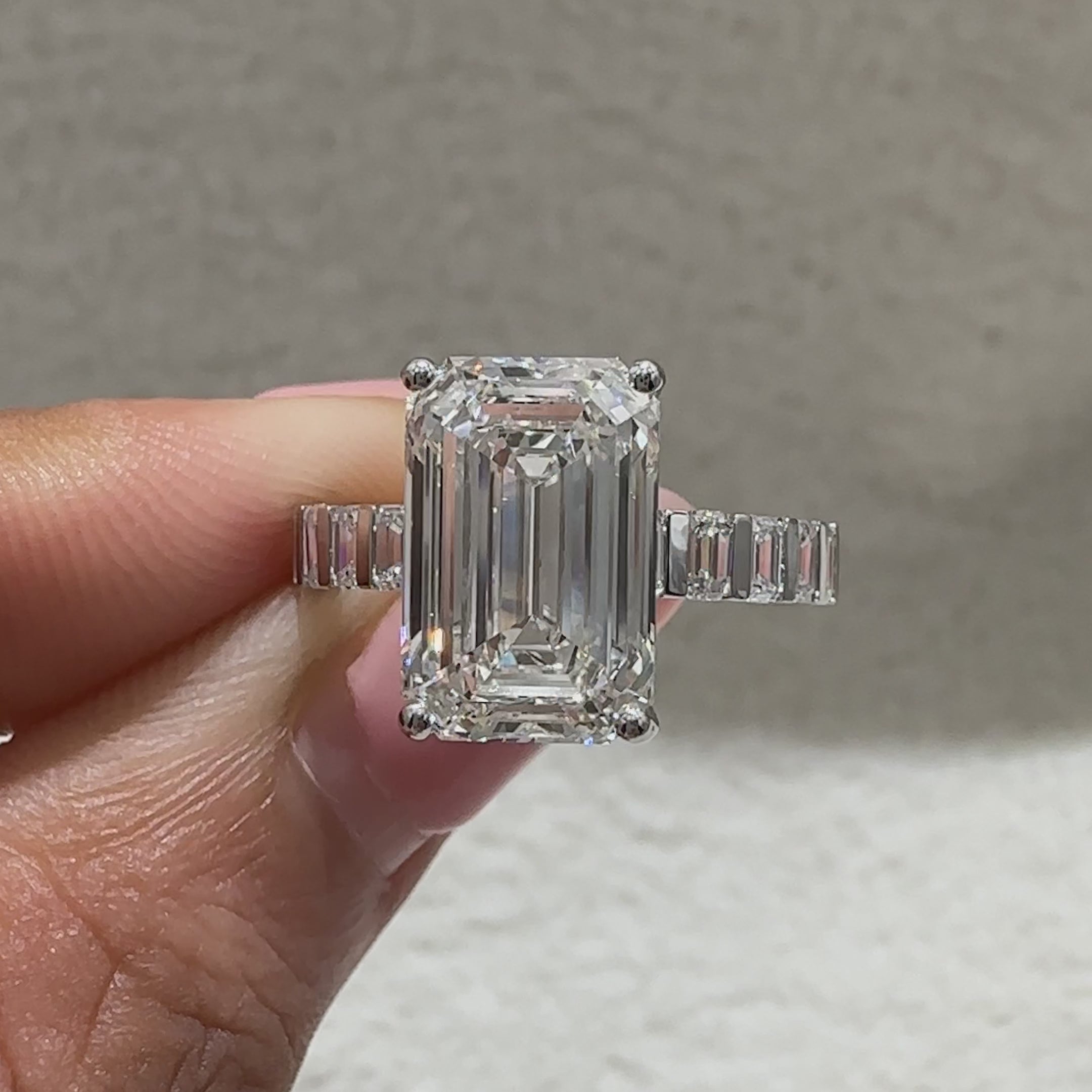 Emerald cut lab grown diamond ring with bar setting accents
