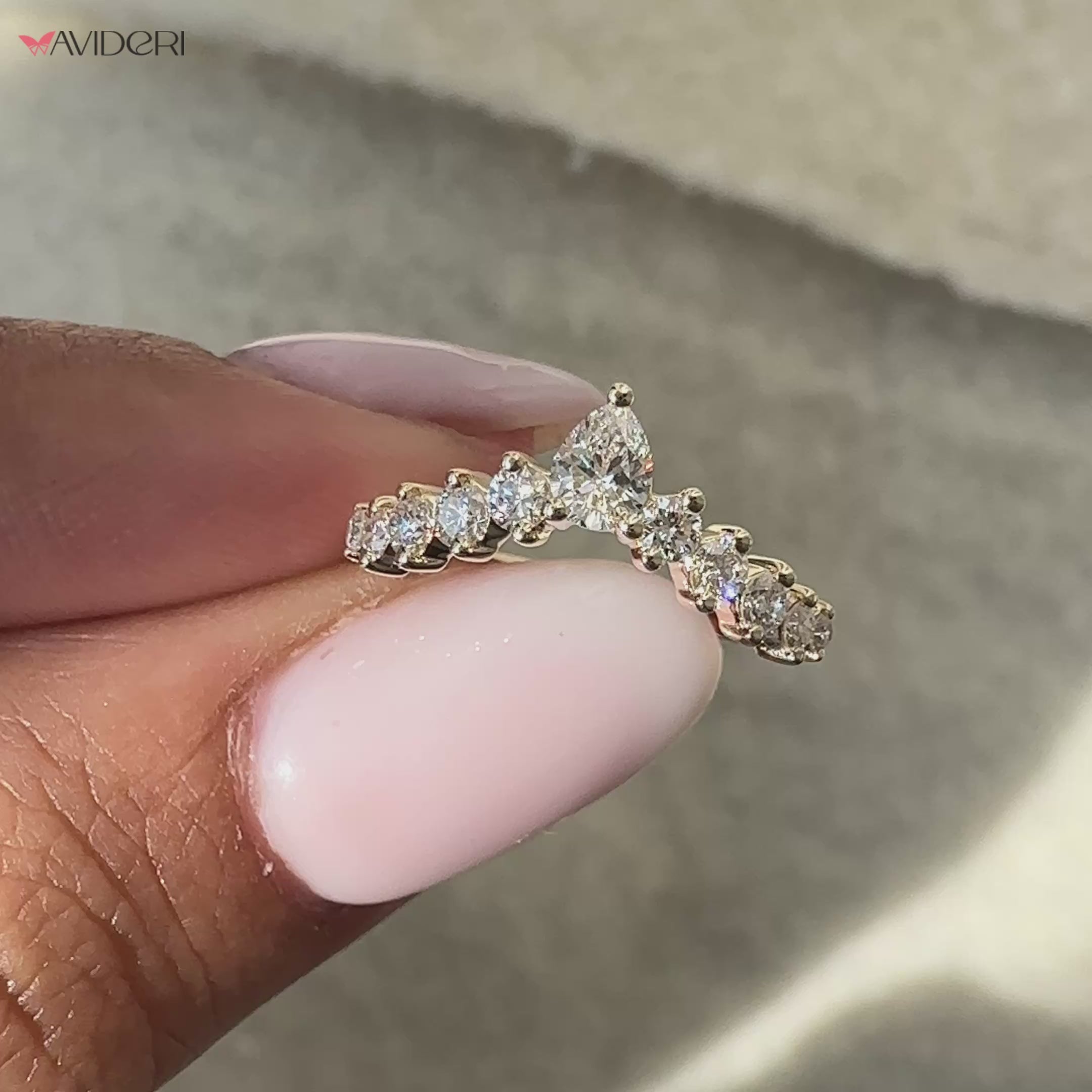 Round diamond band with pear shaped diamond accents for added brilliance.
