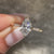 Marquise diamond ring with round diamond pave accents.
