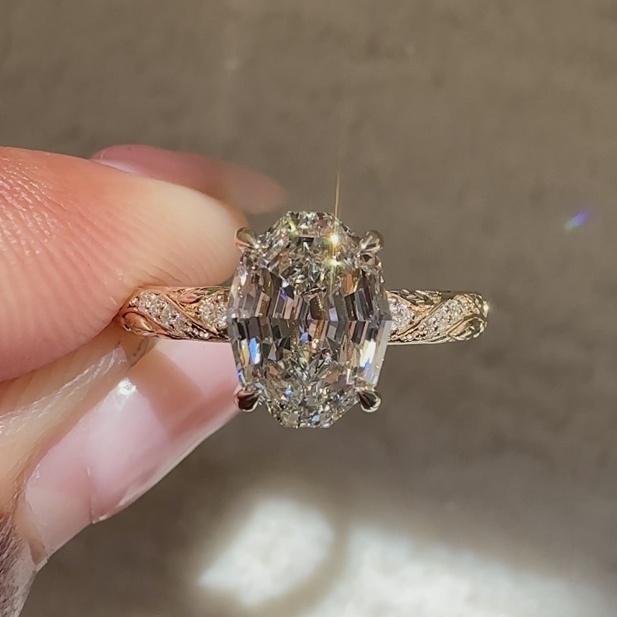 Oval step cut ring with ornate filigree shank
