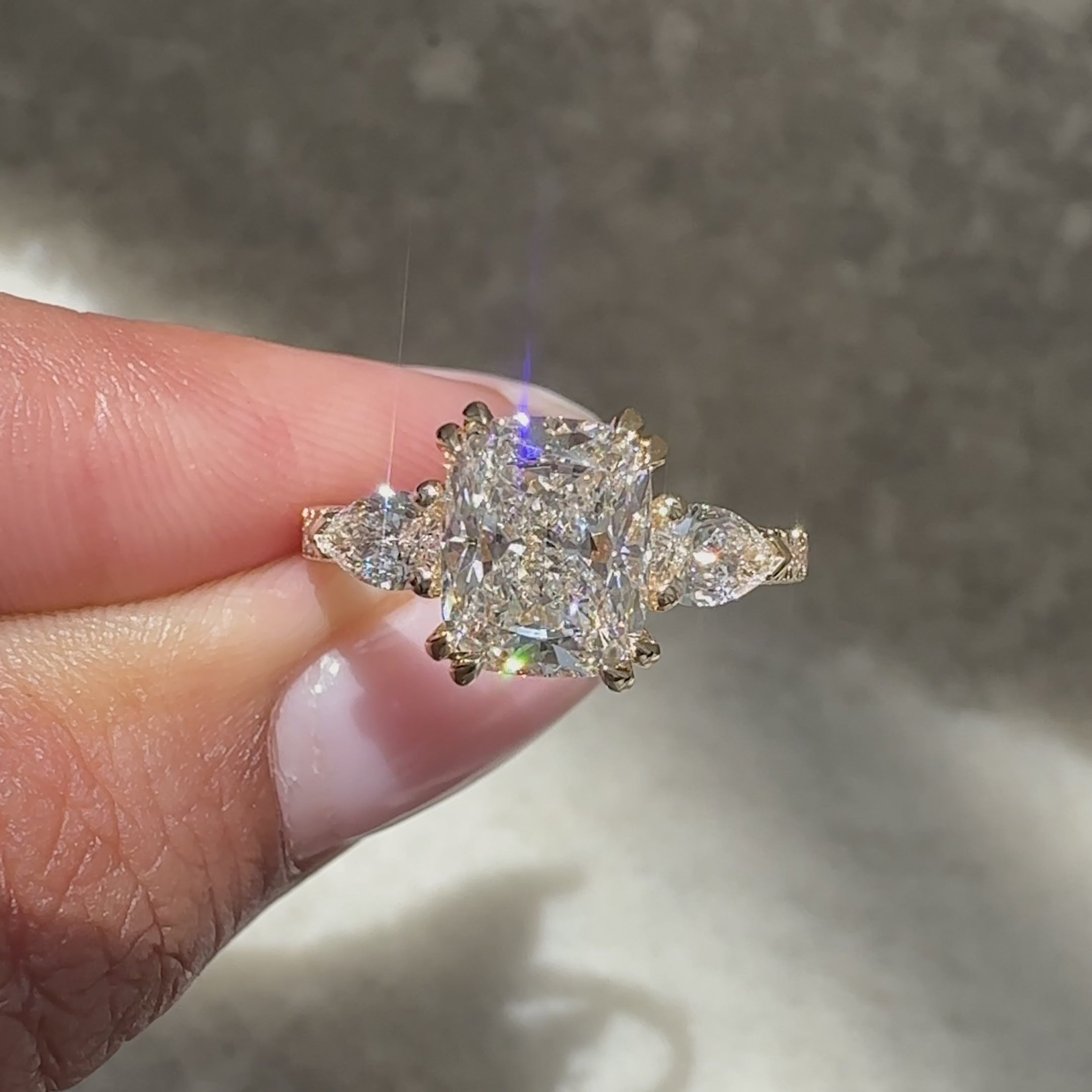 Three stone cushion ring with double prong set.
