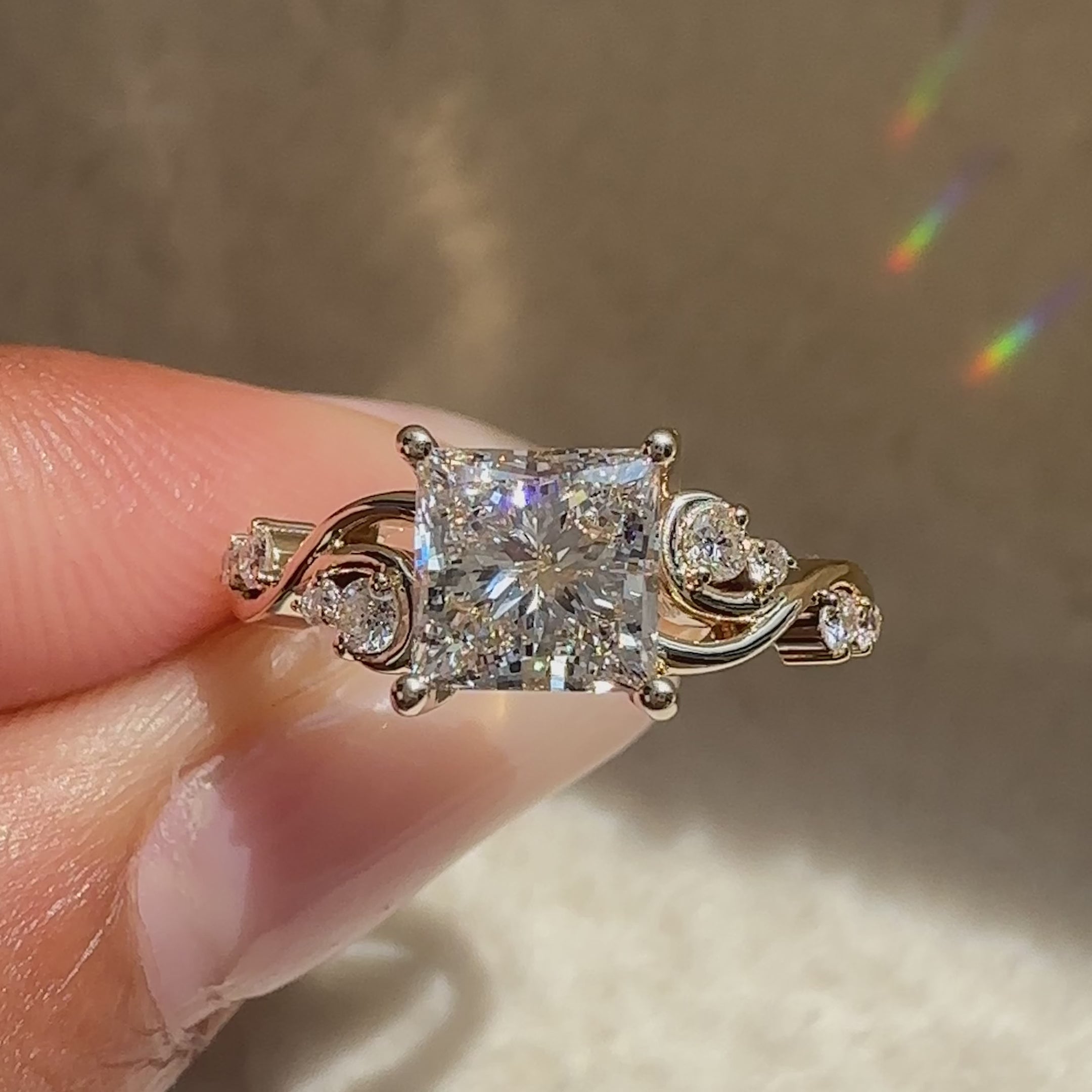 Princess cut diamond ring with round side stones.

